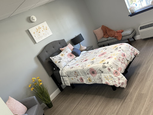 A beautifully styled bedroom featuring floral bedding and a cozy atmosphere.