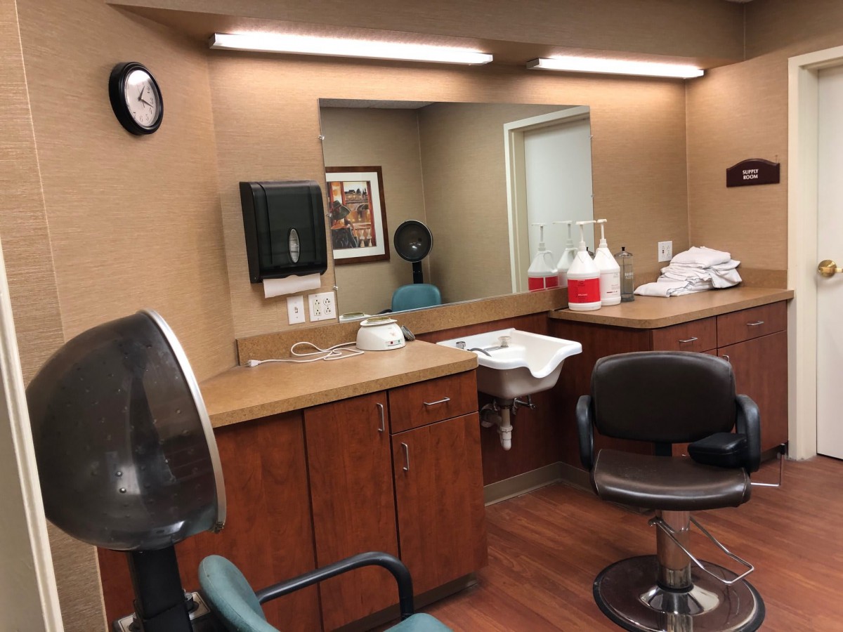 An interior view of a hair salon with chairs and styling stations.
