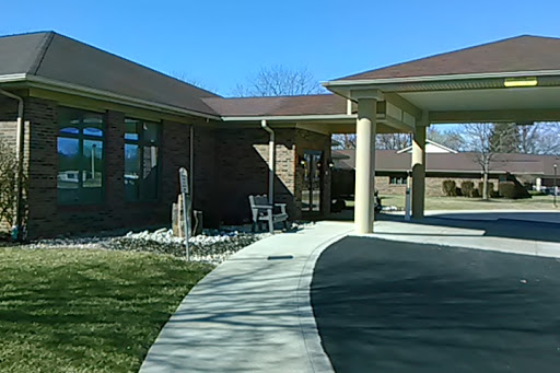 A well-maintained building with a landscaped entrance on a sunny day.