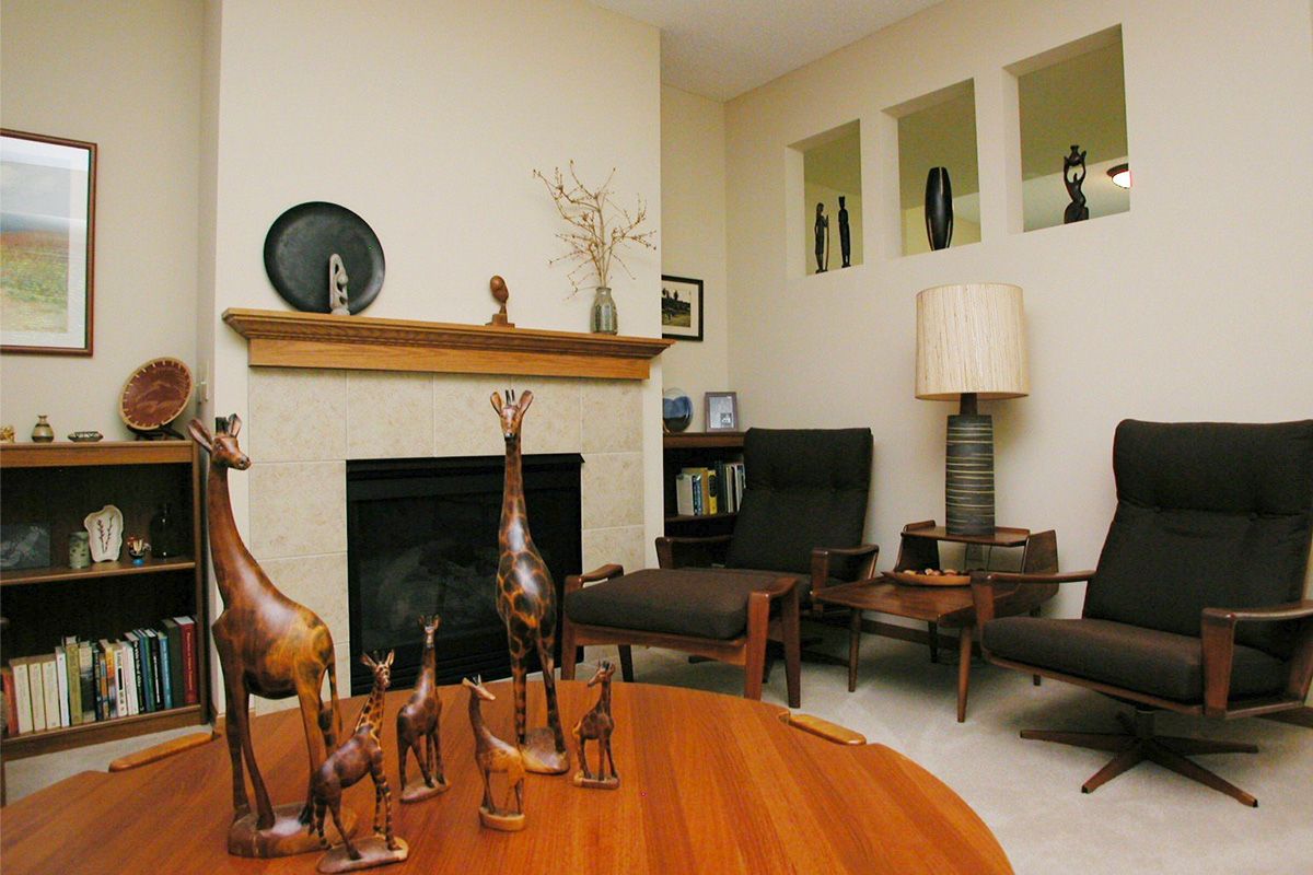 A cozy living room with modern decor, featuring a fireplace and stylish furniture.