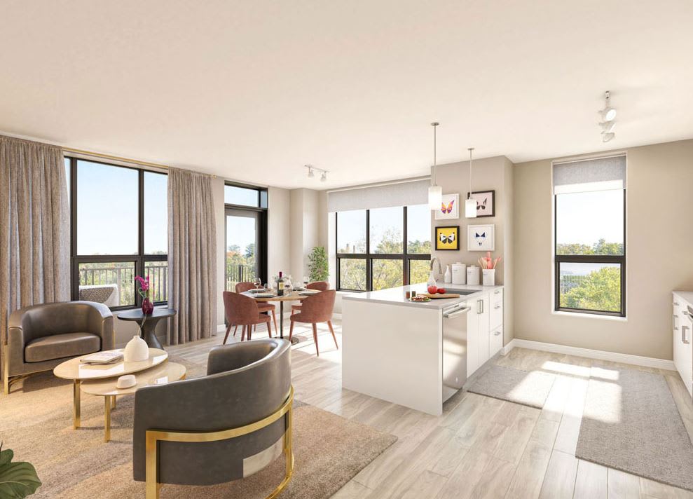 A modern open-concept living room and kitchen with large windows and stylish decor.