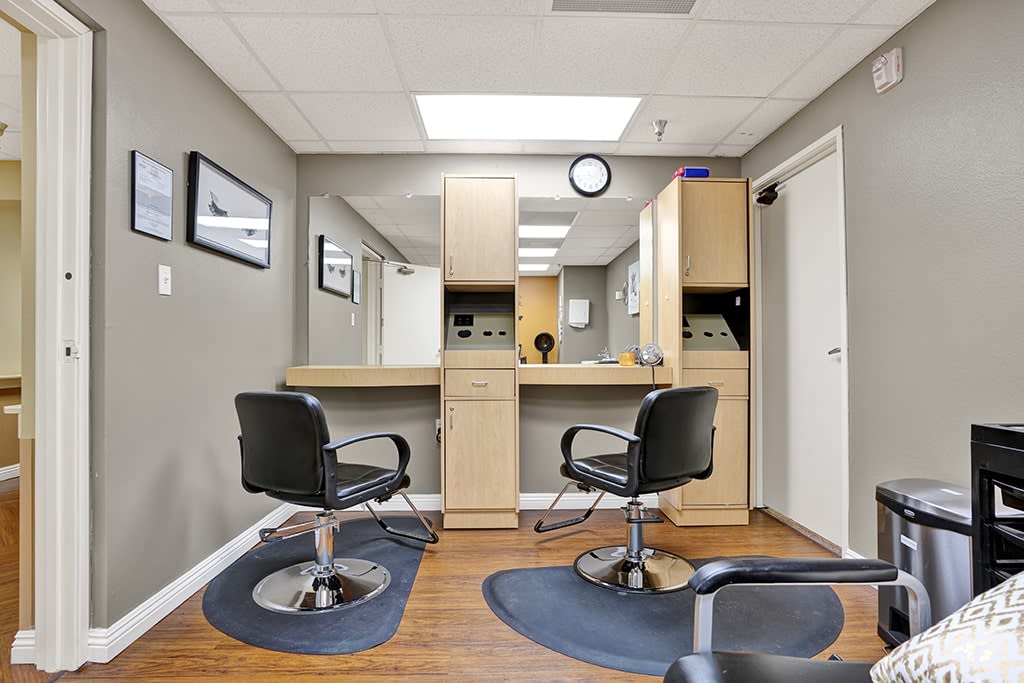 A well-lit interior of a hair salon with stylist chairs and mirrors.
