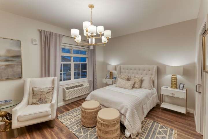A modern, cozy bedroom with elegant lighting and decor.