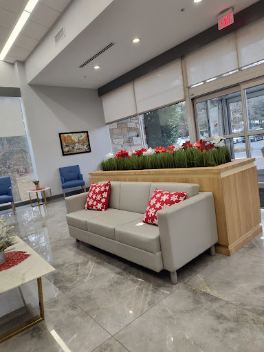 A modern lobby featuring a comfortable sofa and vibrant plant decor.