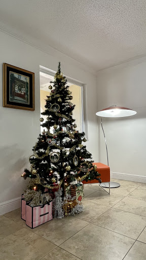 A beautifully decorated Christmas tree in a modern living room setting.