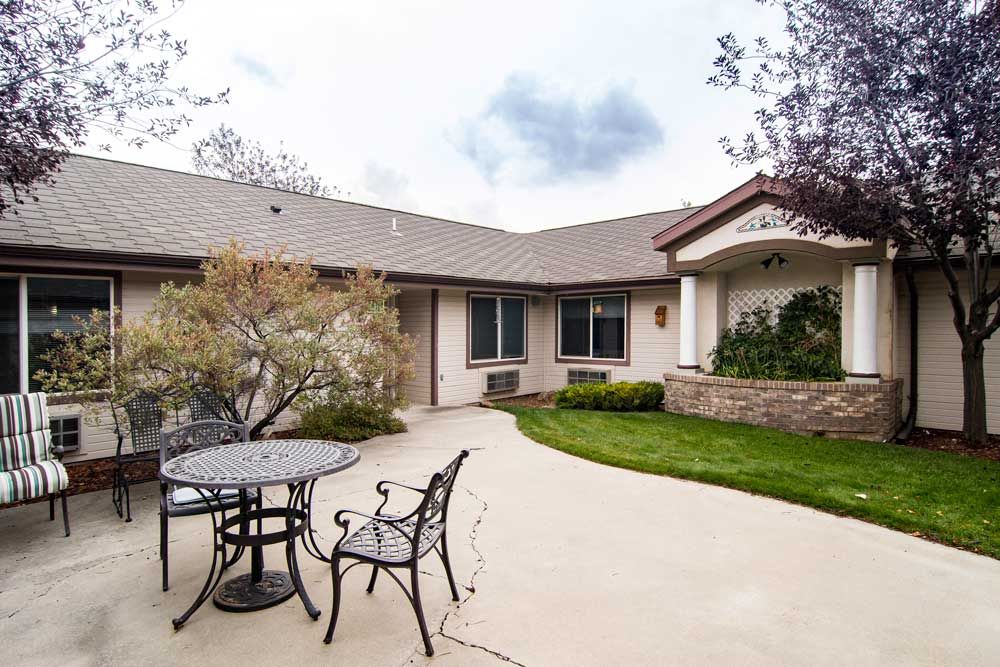 A cozy residential house with a spacious patio and outdoor seating.