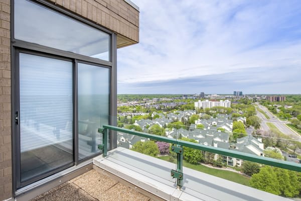 A balcony with a scenic city view on a clear day.