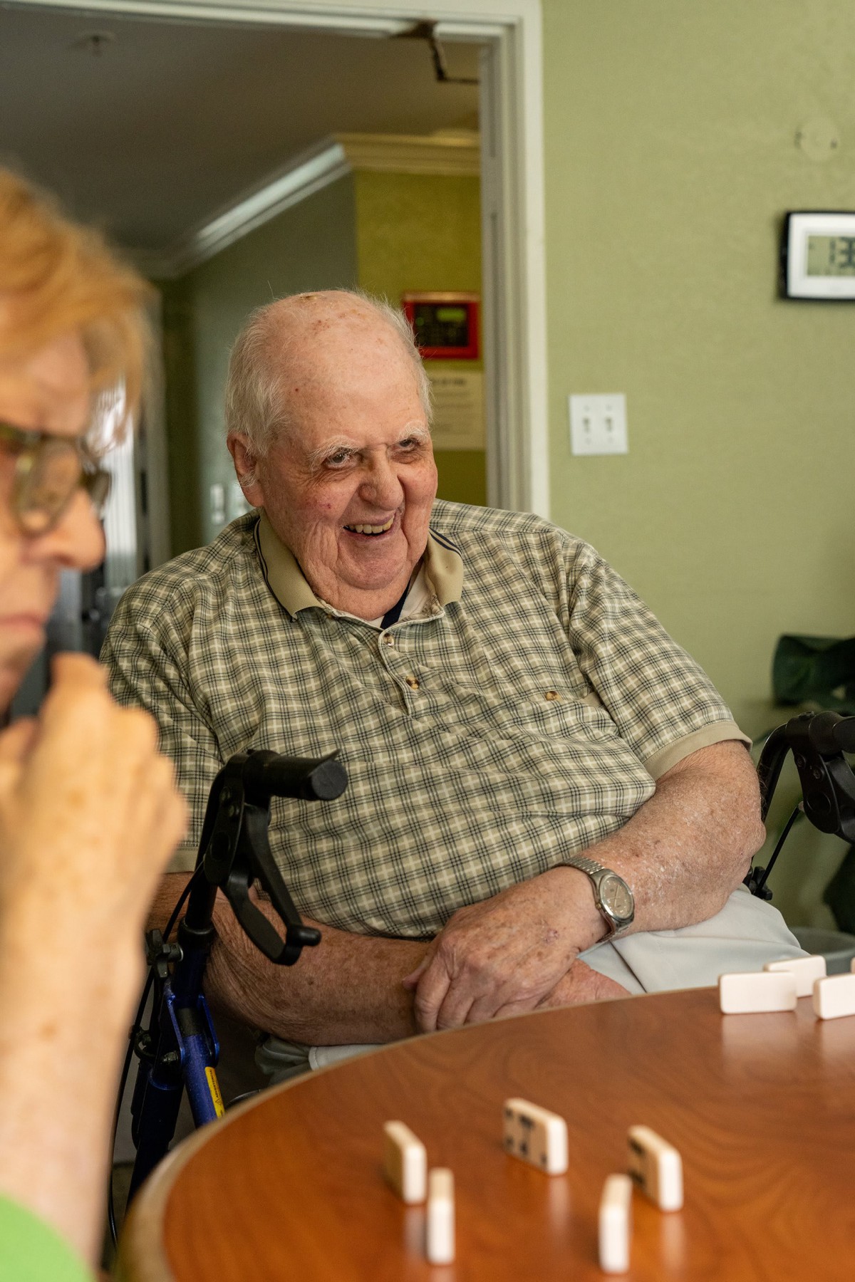 Elderly individuals sharing laughter and conversation indoors.