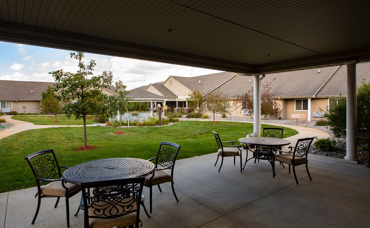 A peaceful patio with outdoor seating overlooking a well-maintained garden.