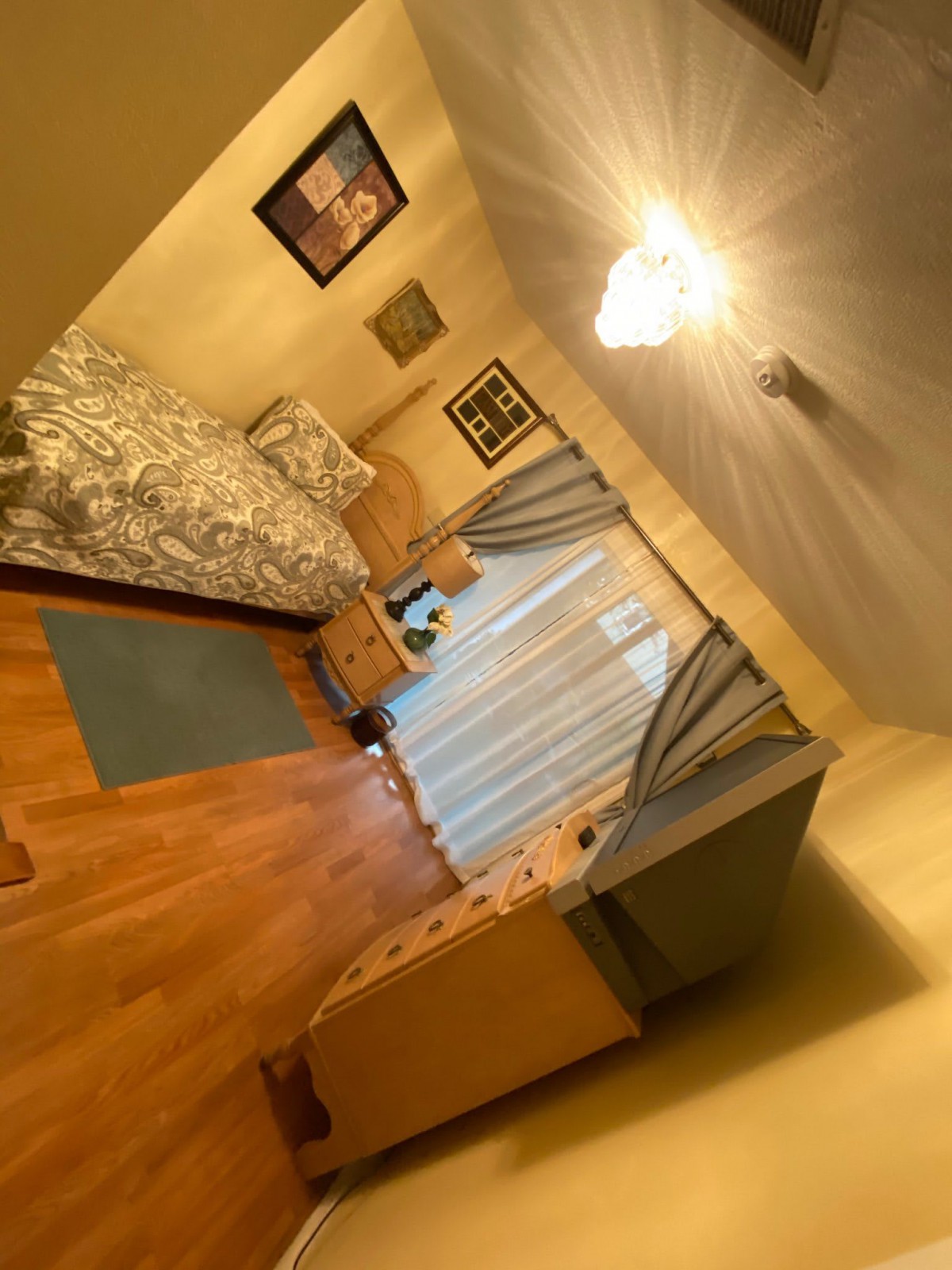 A cozy bedroom with a single bed and elegant decor.