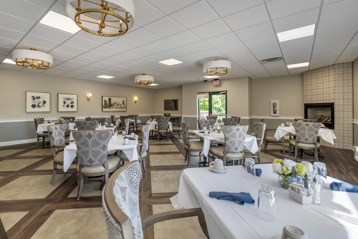 Elegant dining room with neatly arranged tables and chairs.