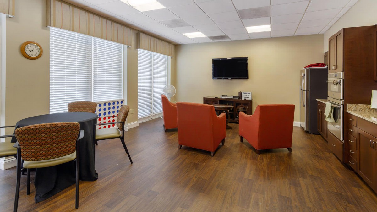 A modern living room with comfortable seating and a wall-mounted television.