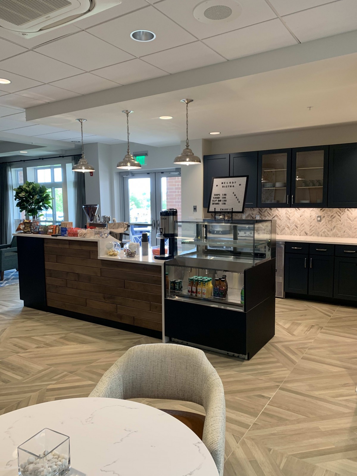 A modern coffee shop interior with a sleek counter and seating area.
