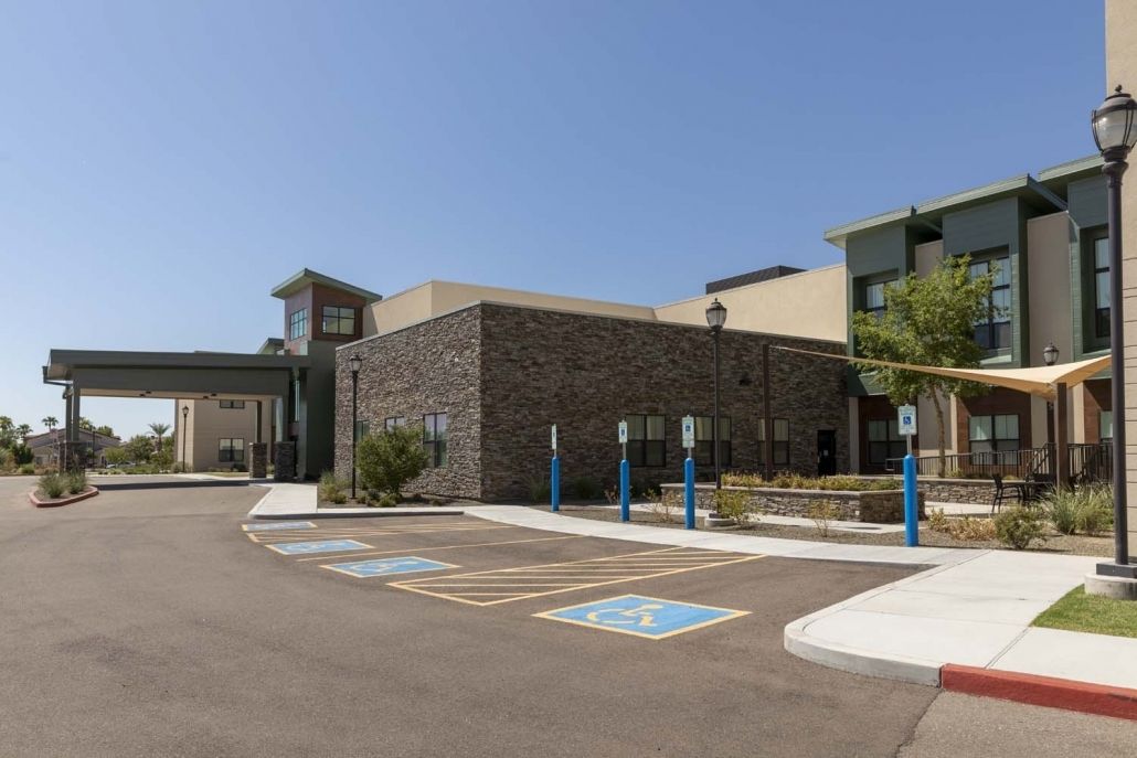 Modern commercial building with designated handicap parking spaces in the foreground.
