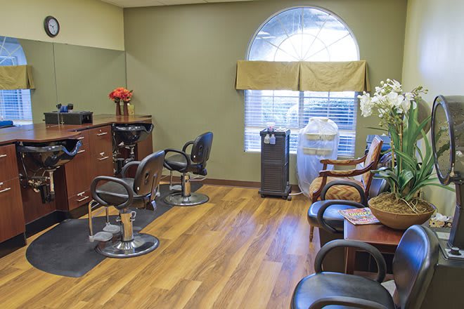 A well-lit hair salon with chairs and mirrors.