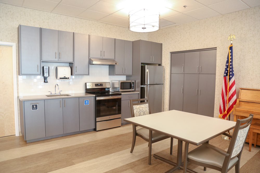 Modern kitchen with gray cabinets and dining area.