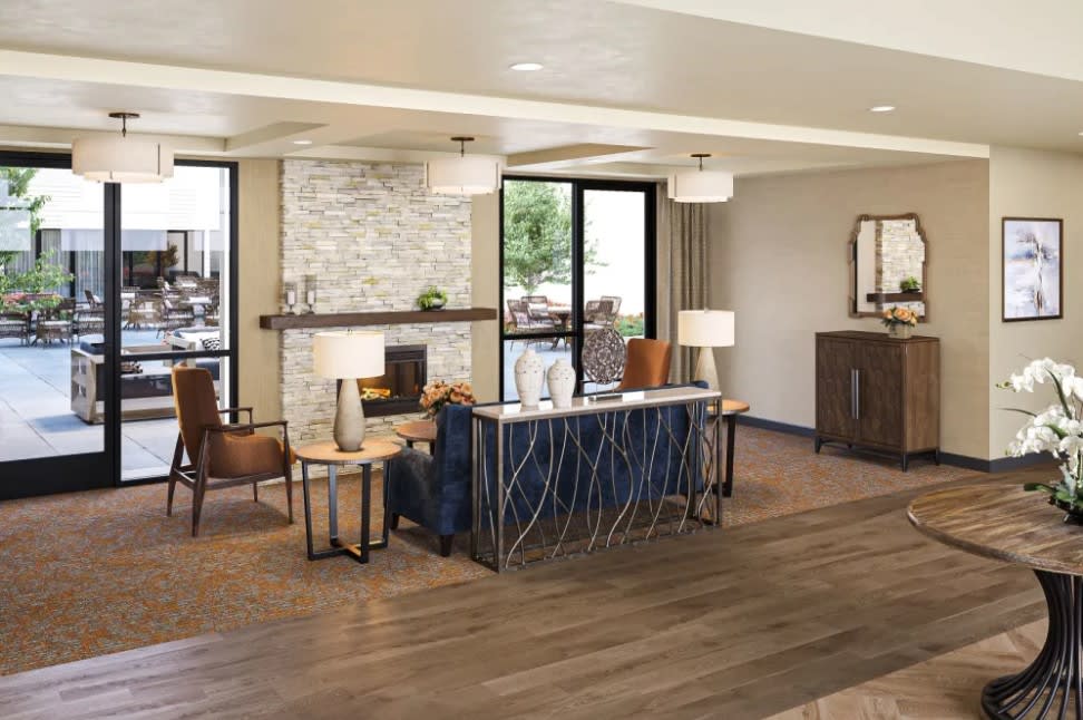 A modern living room with a cozy seating area and a fireplace.