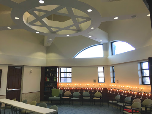 Interior view of a modern synagogue, featuring elegant architectural design and warm lighting.