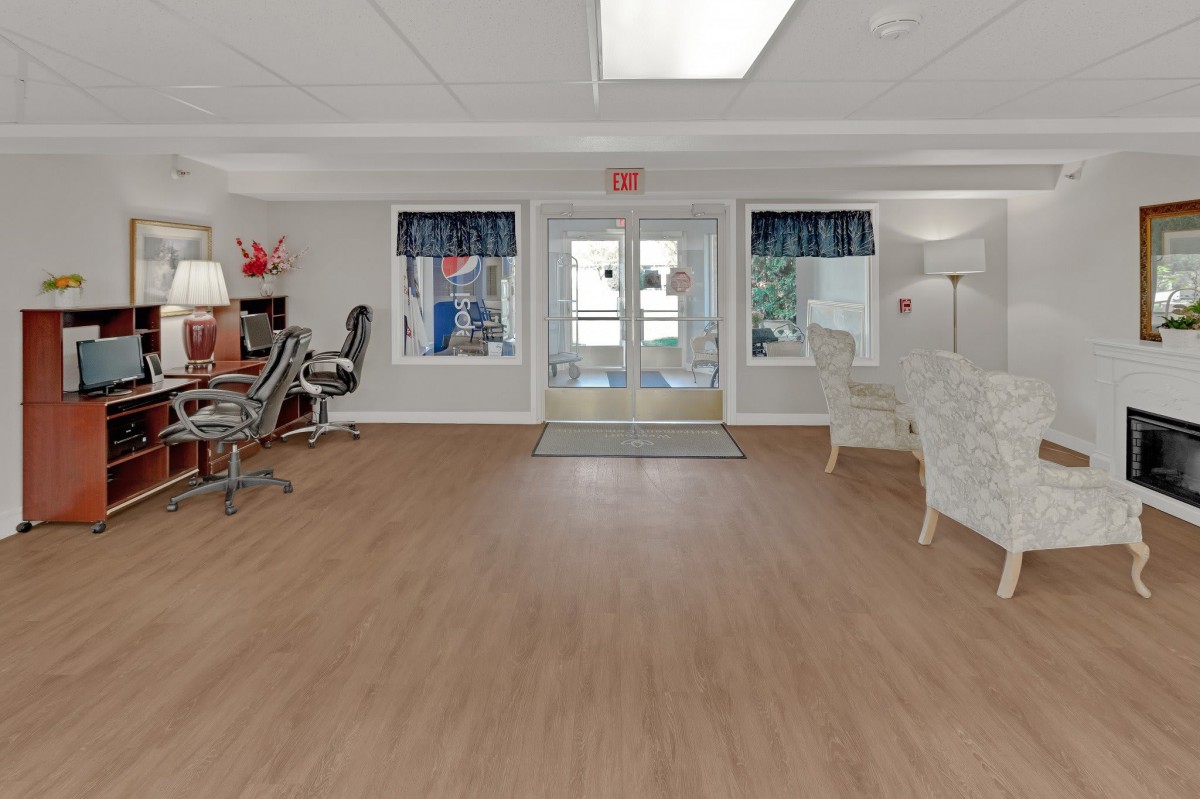 Lobby area with wooden flooring and comfortable seating.