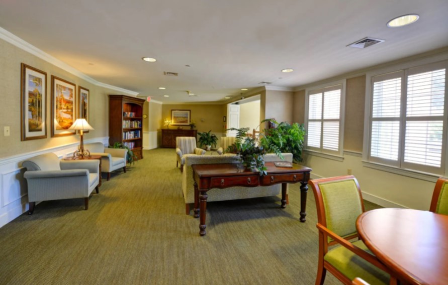 A comfortable lobby or waiting area with chairs, tables, and plants, offering a welcoming atmosphere.