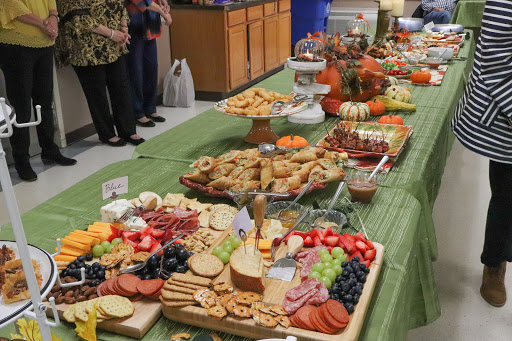 A beautifully arranged buffet table featuring a variety of snacks, fruits, and pastries.