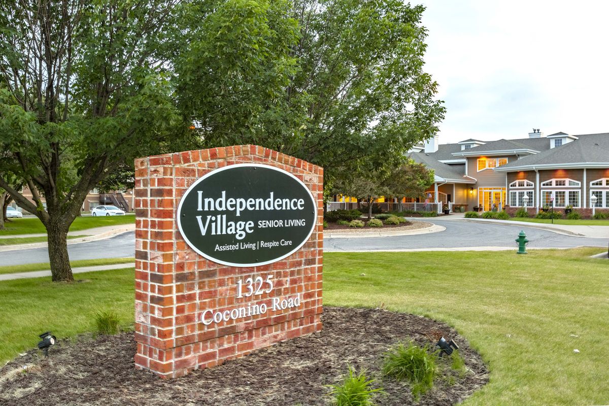Entrance sign to Independence Village with the building in the background.