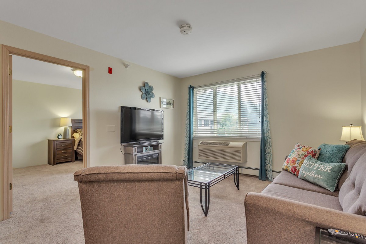 A cozy living room with comfortable seating and a large window letting in natural light.