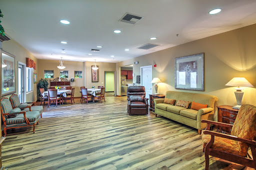 A welcoming lobby area featuring comfortable seating and a wooden floor, designed for relaxation and social interaction.