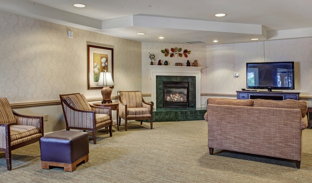 A cozy living room featuring comfortable seating and a fireplace.