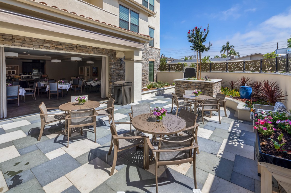 A sunny outdoor patio area with tables and chairs, perfect for gatherings.