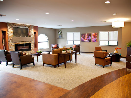 A modern and inviting lounge area equipped with comfortable seating and decorative art, perfect for relaxation.