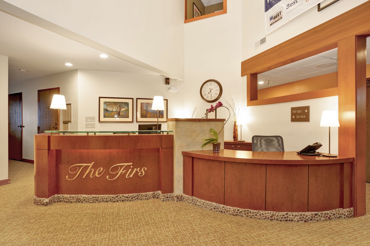 A modern office reception area with a welcoming desk and comfortable decor.