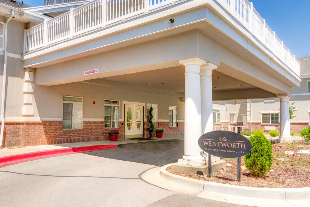 Entrance of a building with columns and signage.