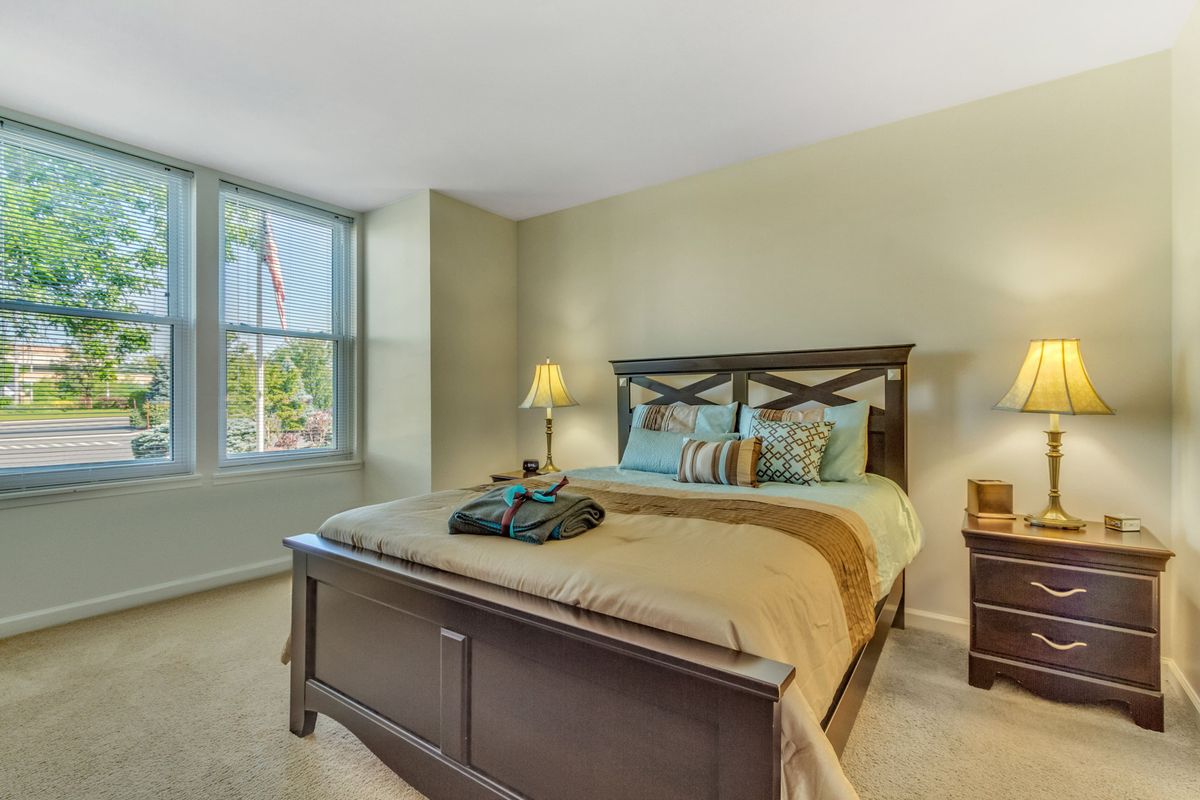 A cozy bedroom with a large bed and a window letting in natural light.