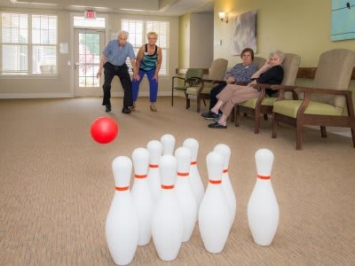 Seniors enjoying an indoor game of bowling.