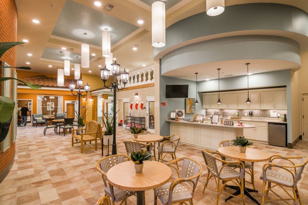 A modern cafe interior with tables, chairs, and stylish lighting.