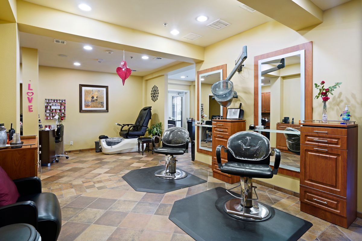 A well-equipped beauty salon interior with styling chairs and mirrors.