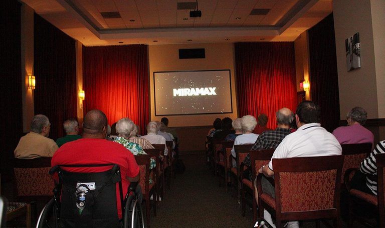 An audience watching a movie in a theater with the Miramax logo on screen.