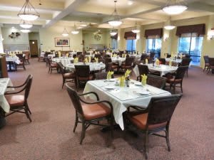 Elegant dining room with tables set for guests.