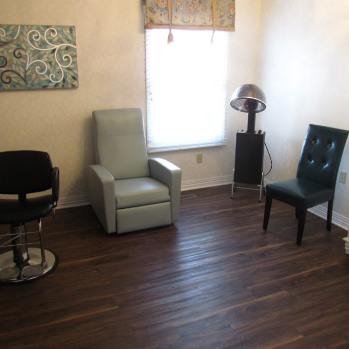 A cozy room with various seating options and a wooden floor.