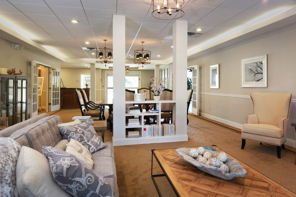 A modern living room with neutral tones, featuring a comfortable sofa, stylish coffee table, and elegant lighting fixtures.