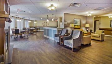 A well-lit lobby area with comfortable seating and a reception desk.
