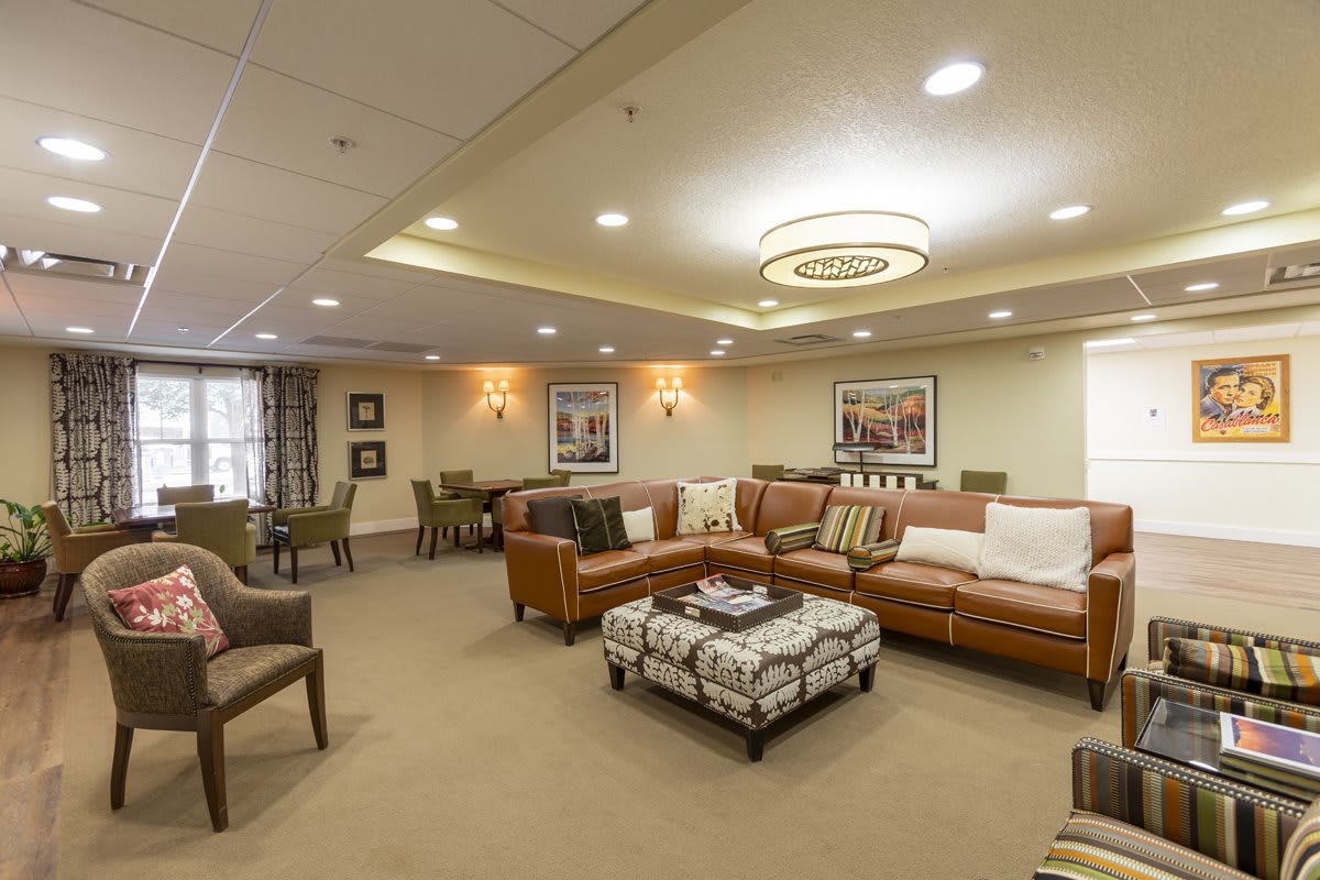 A cozy and well-lit living room with comfortable seating and elegant decor.