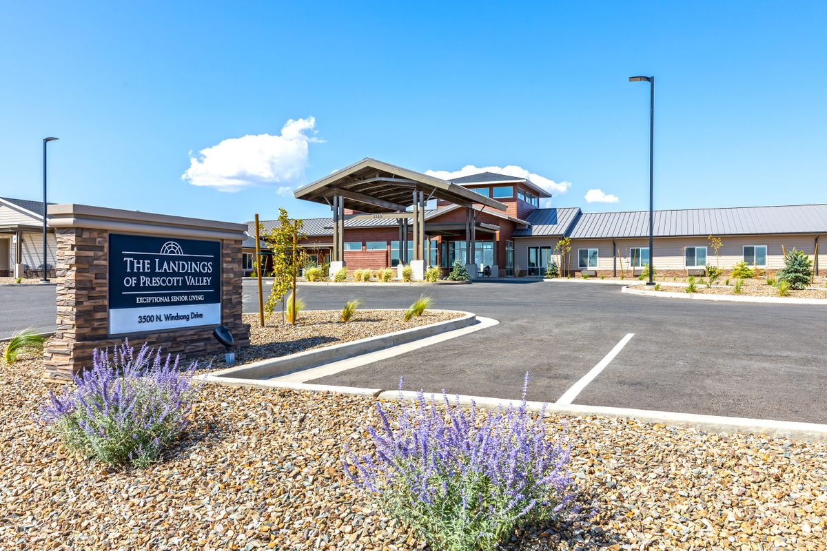 A modern healthcare facility with a well-maintained entrance and parking area, featuring clear signs and landscaping.