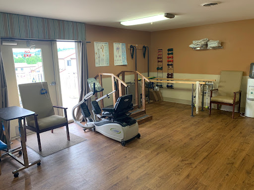 A well-equipped rehabilitation therapy room with exercise equipment and a welcoming atmosphere.