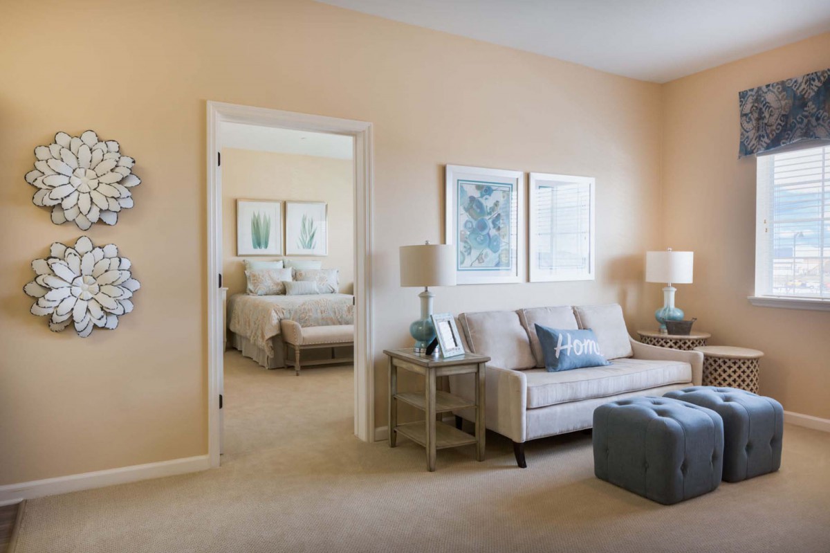 A cozy living space with a comfortable sofa and access to a well-decorated bedroom.