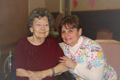A warm moment shared between a caregiver and an elderly resident.