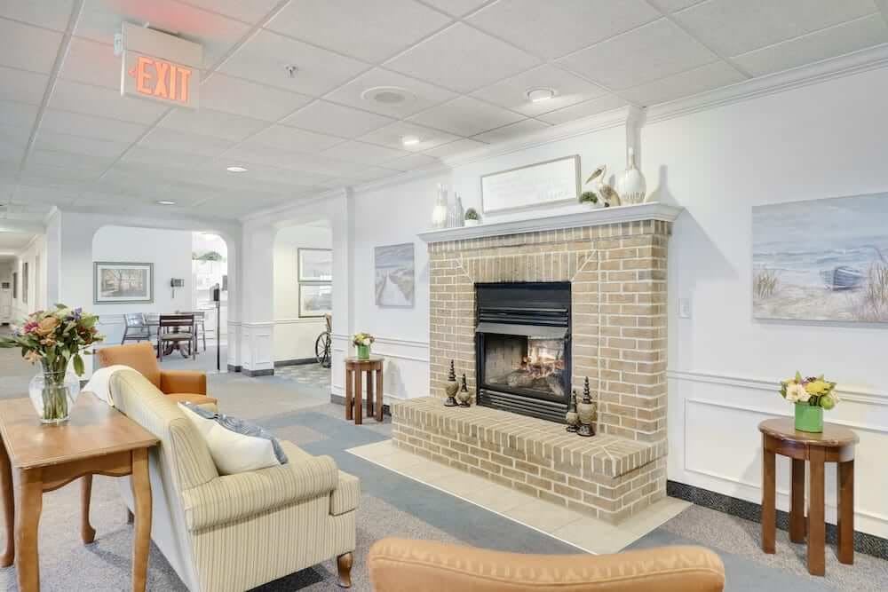 A cozy living room with a brick fireplace and comfortable seating.
