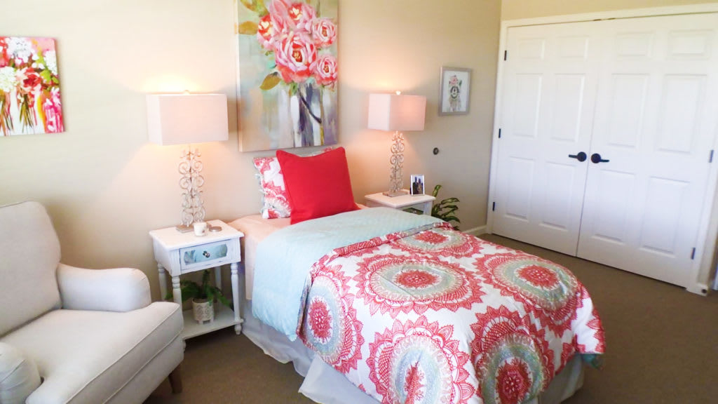A beautifully decorated bedroom with colorful bedding and matching decor accents.