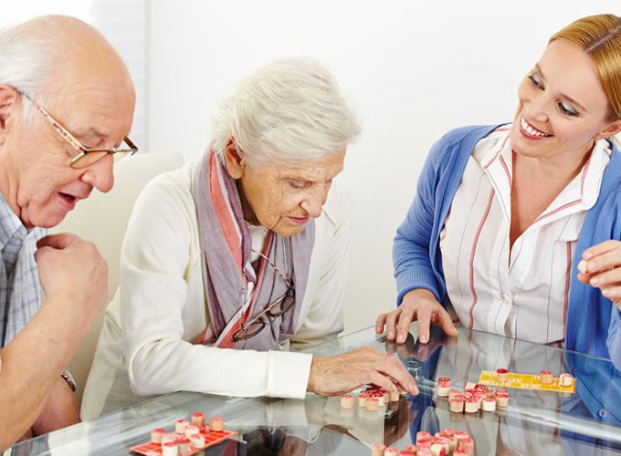 A group of seniors engaging in a board game together.